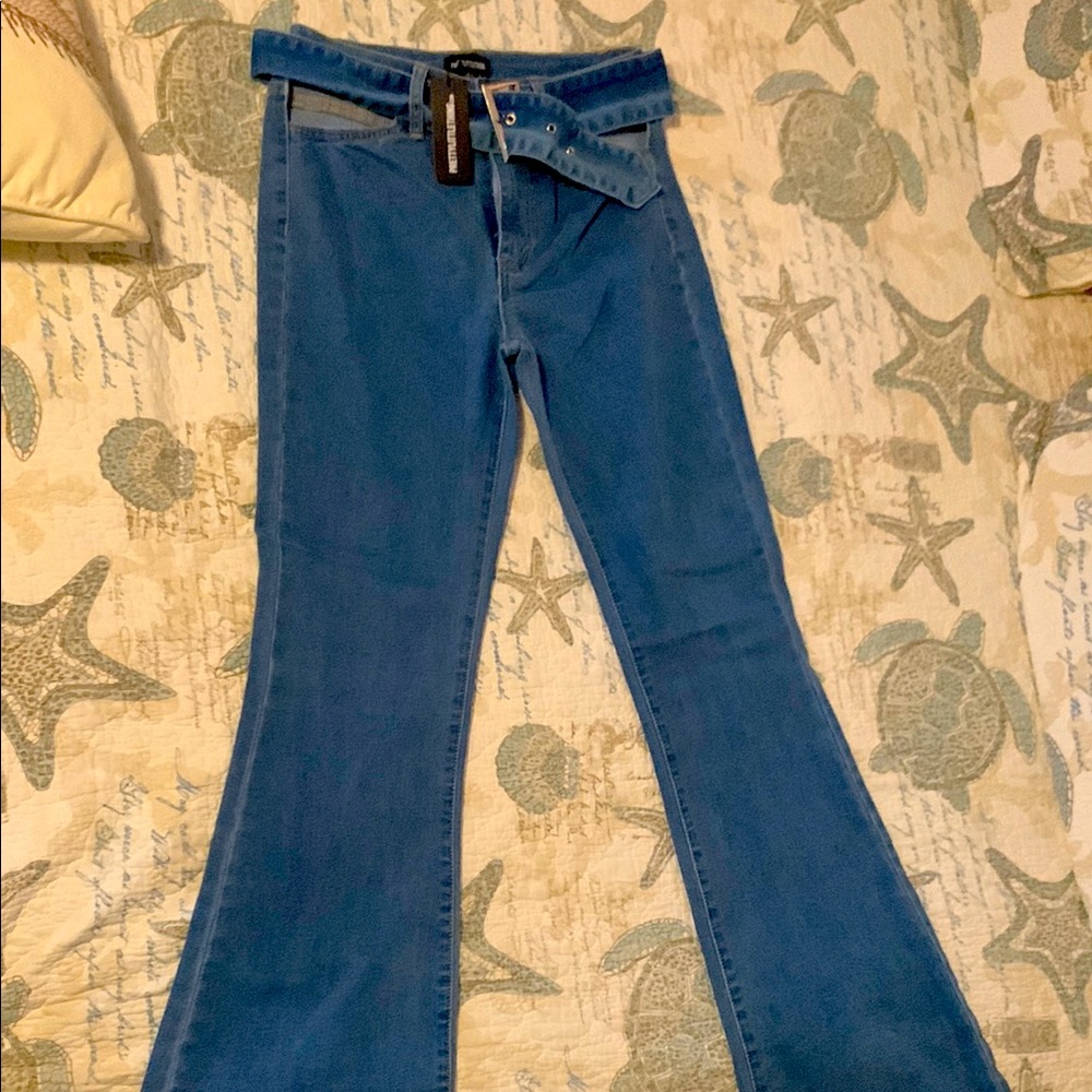 Pretty Little Things. Blue flare denim jeans.  Cut-out front pockets.